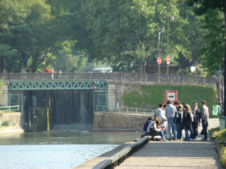 Students on east bank of Canal Saint-Martin, south of Eugène-Varlin bridge